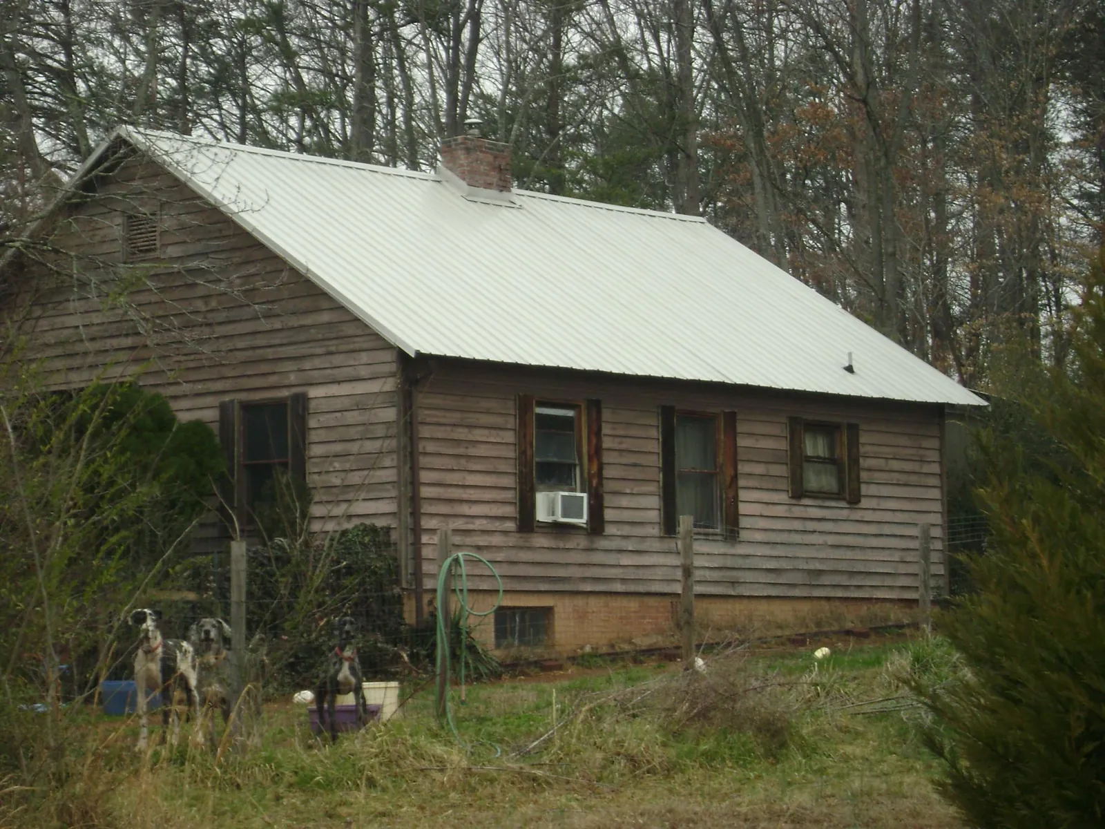 White metal roof on an old wood sided farmhouse, from a Metal Roof Installation job in Fairdale